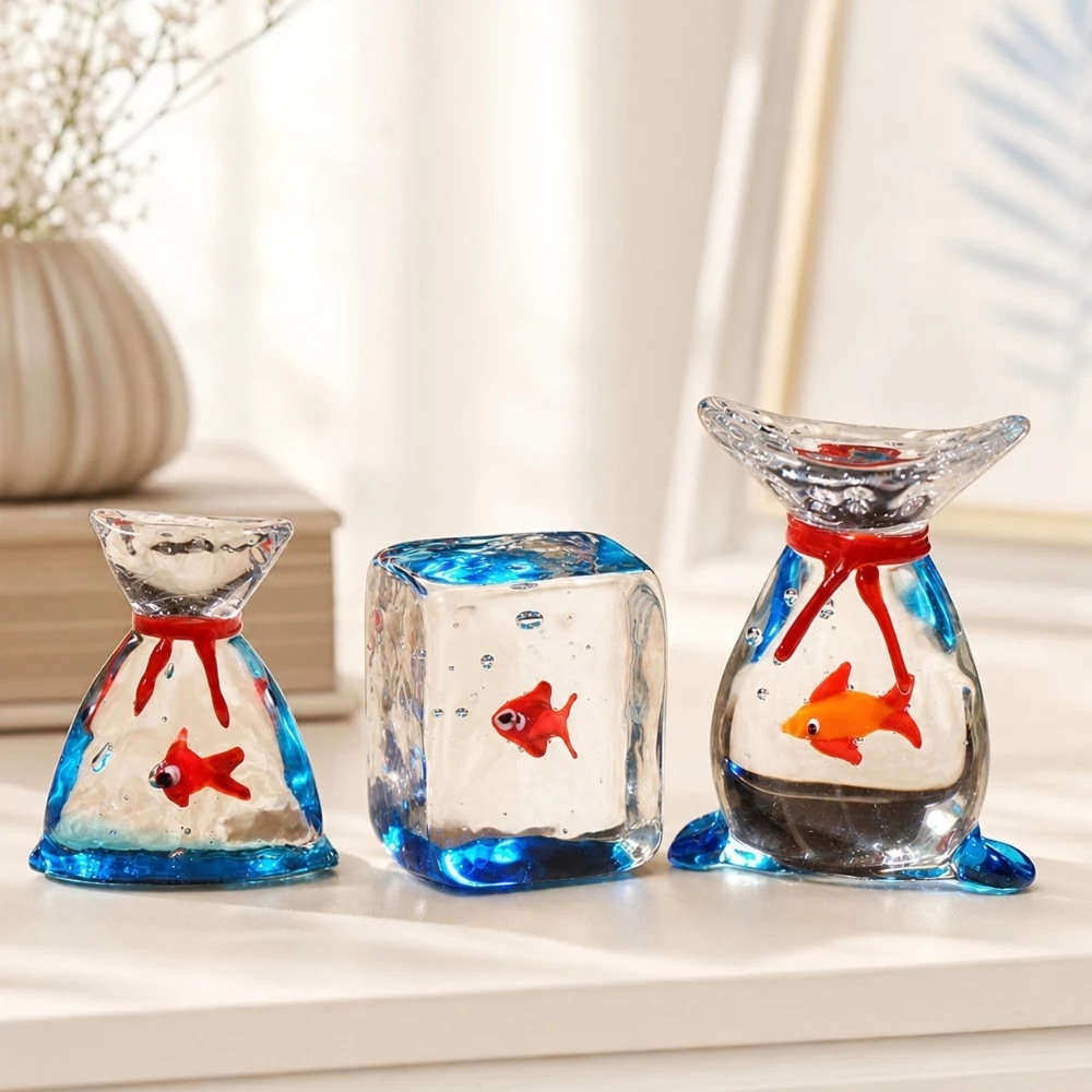 Three handmade glass goldfish ornaments displayed together
