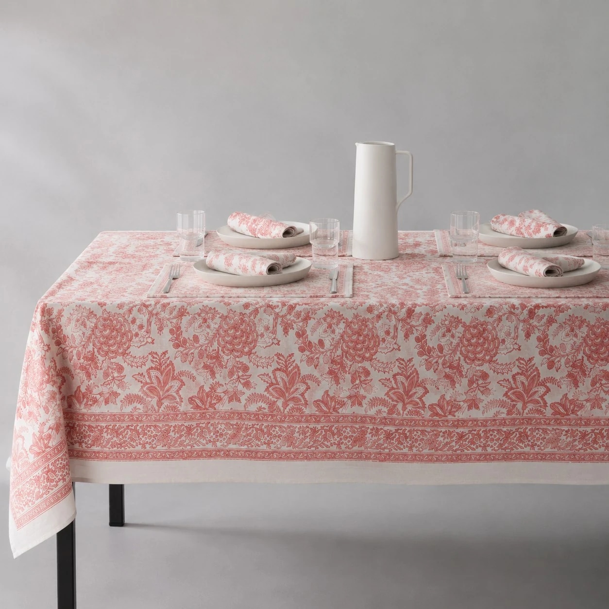 Soft coral floral tablecloth on a dining table